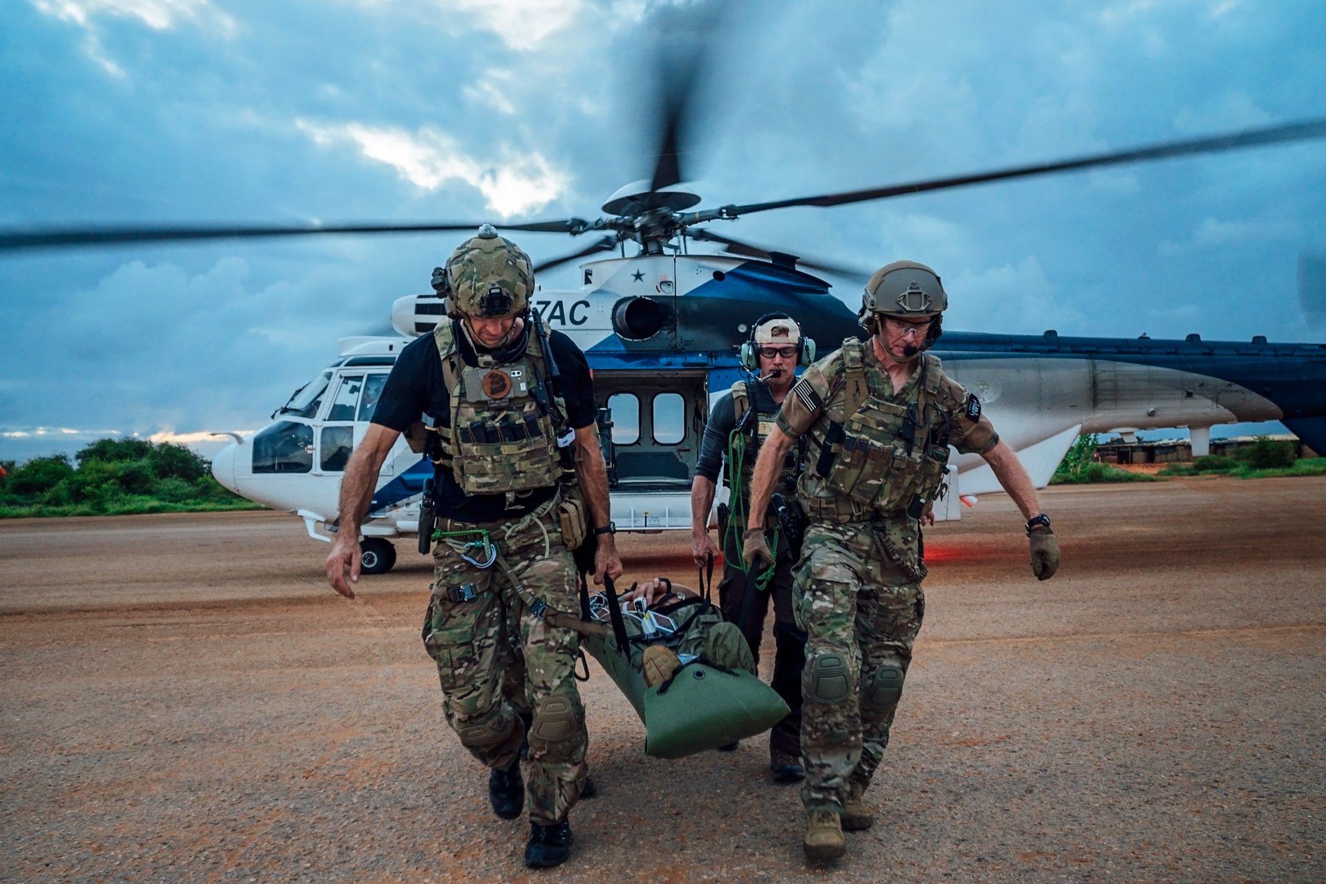 Operators conducting casualty evacuation from helicopter