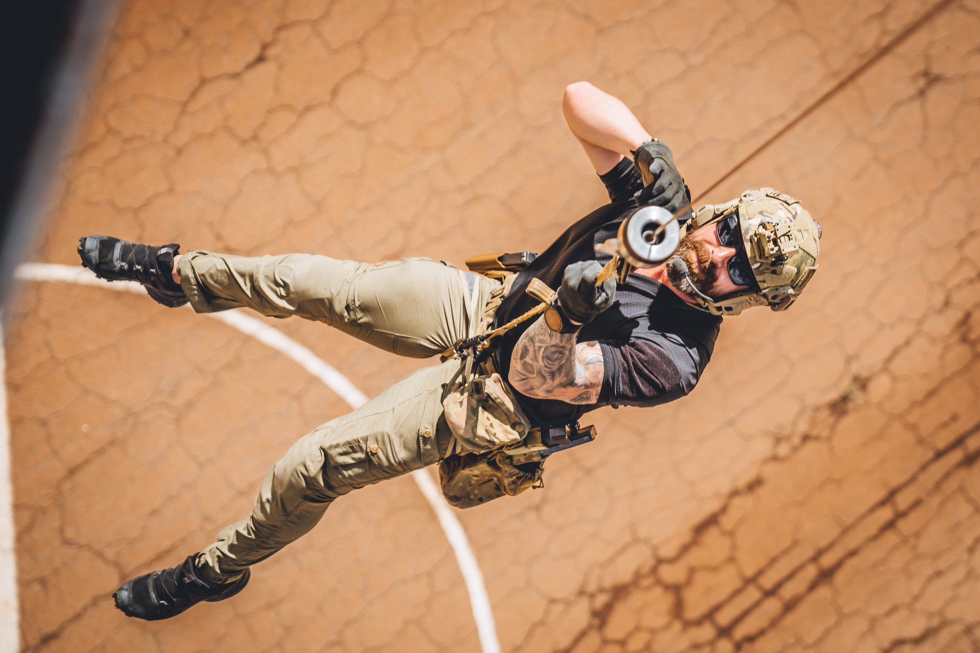 Operator rappelling during training exercise